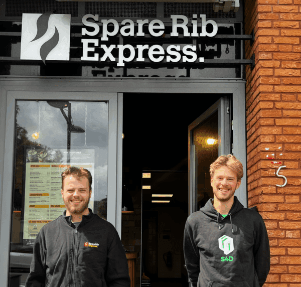Picture of two employees in front of SRE store